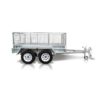 This Premium 12x6 Dual Axle Heavy Duty Tandem Trailer for sale features high mesh sides and a tow hitch, with its silver metal frame and dual wheels reflecting on a white background. Rated at 3500KG ATM, this utility trailer is both robust and functional.