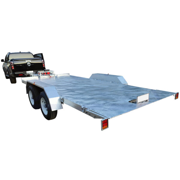 A black vehicle is towing a silver Hydraulic Tipper Car Trailer with a 3500KG ATM and a spacious 16.4x6.6FT deck, featuring two wheels on each side and lacking side panels or rails, designed for transporting large items or vehicles.