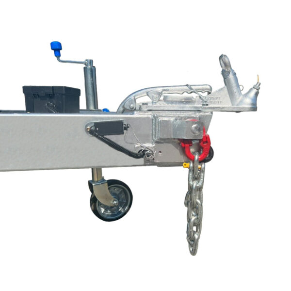 A close-up of the metal hitch on the Hydraulic Tipper Car Trailer (3500KG ATM, 16.4x6.6FT) shows a hand crank, safety chains, and wheel for secure attachment and stabilization. Features include a blue-handled lever and a red chain attachment for enhanced security.