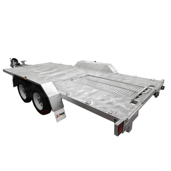The Dual Axle Premium 3200KG Car Trailer features a spacious 15.7x6.6FT deck, a silver flatbed design with textured surface and central lattice. It includes wheel arches with reflective markers and a hitch mechanism for towing at the front.