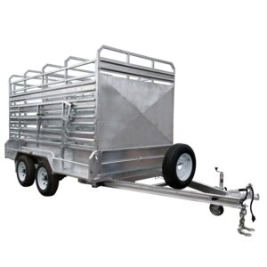 A 12x6 silver livestock trailer with a dual axle design. It includes side rails, ramps, a side door with bars, a front-mounted spare tire, tow hitch, and safety chains. Rated for 3500KG ATM.
