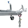 Close-up of a metal trailer hitch with a coupling mechanism, safety chain, and support wheel. Attached to a metal frame, it features a blue handle crank for adjustment. Product: 8x5 Single Axle Box Trailer ATM 750KG With Jockey Wheel.