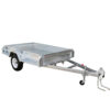 The 7×5 Single Axle Box Trailer ATM 1400KG with Jockey Wheel features a flatbed design, side rails, front hitch with safety chains, and a black rubber wheel with a white rim.