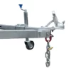 The 6x4 Single Axle Box Trailer ATM 750KG features a metallic hitch with a blue handle and is mounted on a frame with a small wheel. Below, a heavy-duty chain with a red hook hangs, and it includes a coupler for towing connections.