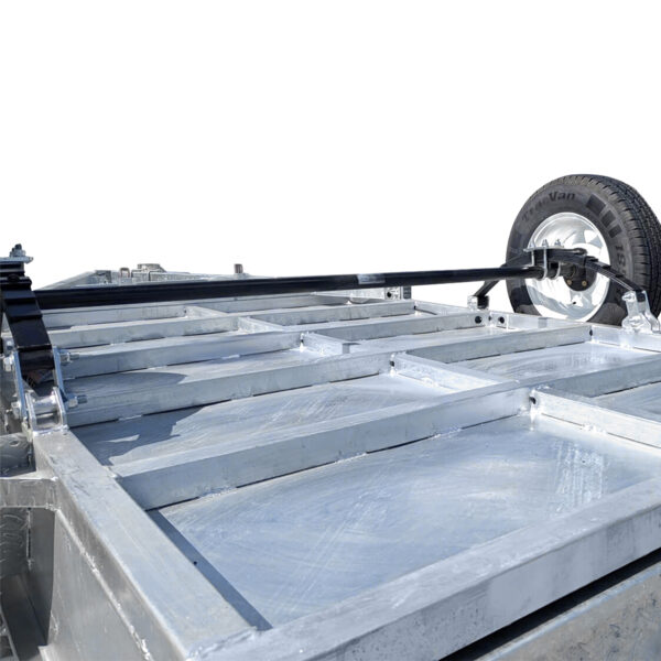 A close-up of the 7×4 Single Axle Box Trailer ATM 750KG With Jockey Wheel, featuring its metal chassis and spare tire mounted on the frame, shot from a low angle against a white background.