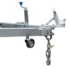 Close-up view of a Premium 8x5 Dual Axle Heavy Duty Tandem Trailer - 2000KG ATM, highlighting its metal trailer hitch mechanism with a coupling lever, a blue-handled jack, safety chain, and sturdy wheels for optimal towing connections.