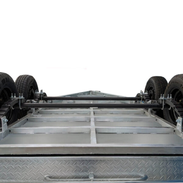 Low-angle view of the Premium 10x6 Dual Axle Heavy Duty Tandem Trailer (3200KG ATM) chassis with four black tires, highlighting its sturdy frame and suspension system against a white background.