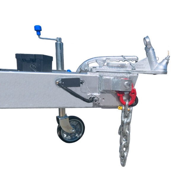 Close-up of an 8x4 Galvanized Plant Trailer, showing a silver metal frame with a coupling device. A safety chain hangs below, with a wheel on the left. A black storage box and blue handle are in the background.