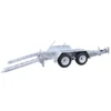 A silver, dual-axle car trailer with two extended loading ramps and white wheel rims, designed for towing vehicles. The trailer has a tilt bed, hitch, and is set against a plain white background.
