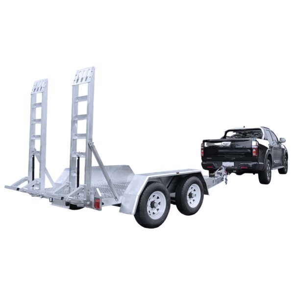 A black truck is towing a metallic utility trailer with dual axles and two large ramps at the back, designed for transporting heavy equipment or vehicles. The trailer is empty and parked on a plain white background.