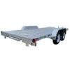 The Dual Axle Premium 3500KG Car Trailer features a spacious 16.4×6.6FT deck with a metallic surface, dual axles, and two wheels per side. Rear lights are visible, with no sidewalls or roof, making it sturdy for transporting large or heavy items.