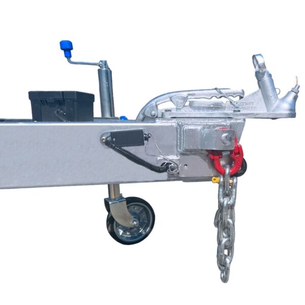 The Premium 10x7 Galvanized Flat Top Trailer with 3500KGS ATM and Ramps features a close-up of a coupling mechanism, safety chain, support wheel, blue handle, and electrical connector for vehicle attachment.
