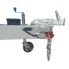 Close-up of the 12×7 Dual Axle Hydraulic 3-Way Tipper Flat Top Trailers hitch showing its metal frame, coupling mechanism, chain, and wheel assembly. It features an adjustable handle and a black box on the frame. Isolated on a white background.