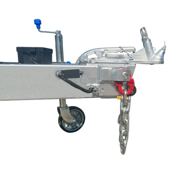Close-up of the 12×7 Dual Axle Hydraulic 3-Way Tipper Flat Top Trailers hitch showing its metal frame, coupling mechanism, chain, and wheel assembly. It features an adjustable handle and a black box on the frame. Isolated on a white background.