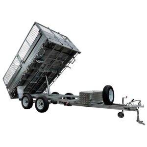 The 12×7 Dual Axle Hydraulic Tipper Tandem Box Trailer - 3500KG ATM With Ramps features an inclined, mesh-sided cargo bed, a diamond-plate storage box, a spare tire on the tongue, a manual handbrake, and a towing hitch for hauling.