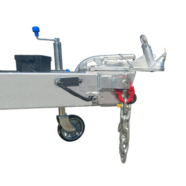 The 12×7 Dual Axle Hydraulic Tipper Tandem Box Trailer - 3500KG ATM With Ramps features a metal hitch with a red connector, safety chains, a maneuvering wheel, a blue-handled lever, and a black plastic box.