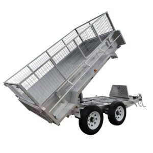 The 10×5 Dual Axle Hydraulic Tipper Tandem Box Trailer - 3500KG ATM With Ramp Holders is a silver, metal utility trailer featuring a tilt bed, two wheels, mesh side panels, and a front coupling mechanism for heavy load transport.