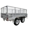 The 10×5 Dual Axle Hydraulic Tipper Tandem Box Trailer - 3500KG ATM with Ramp Holders is a metal utility trailer with high mesh sides, robust build, and dual wheels. It is open-topped for transporting goods or equipment and set against a white background.