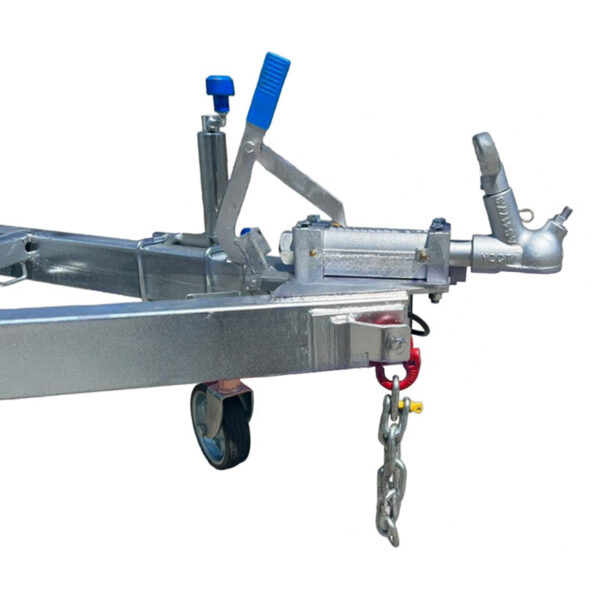 Close-up of a metal trailer coupler with a blue handle on the Twin Jetski Roller Trailer – ATM 1400kg. It is attached to a steel frame with chains hanging and features a small wheel for mobility.