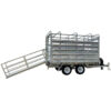 The 12x7 Dual Axle Flat Top Cattle/Livestock Trailer has a silver finish, features two wheels on each side, an open design with metal bars, side rails, a ramp for loading animals on the left side, and a front hitch for towing. It has a 3500KG ATM capacity.