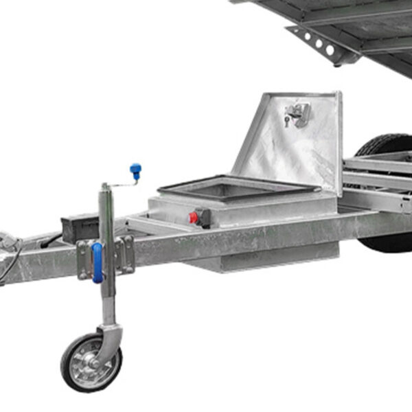 Close-up of the 8x5 Hydraulic Tipper Single Axle Box Trailer (ATM 1800kg) featuring a sturdy metal frame, front small wheel, crank handle, and storage compartment; part of a larger vehicle appears at the top right.