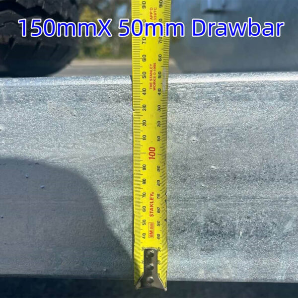 A yellow measuring tape shows a width of 150mm against the metallic drawbar of the 7.0m Galvanized Dual Axle Boat Trailer with 3500kg ATM, designed for boats from 6.2m to 7.0m (20.3ft-23ft). Blue text above reads “150mmX 50mm Drawbar.”.