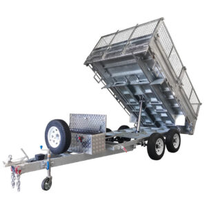 The 14x7 Dual Axle Hydraulic Tipper Tandem Box Trailer - 4500KG ATM With Ramps is shown with its cage raised, featuring a hydraulic tipping mechanism, spare tire, and lockable toolbox mounted on the front frame.
