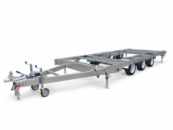 A Premium 20ft Tri-Axle Container Trailer 4500KG ATM (Pre-order), featuring a galvanized steel chassis with three wheels per side, a front tow hitch, and support stands, designed for heavy loads or tiny home foundations, is shown on a white background.