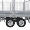 A close-up side view of the Premium 10x7 Galvanized Flat Top Trailer with 4500KGS ATM, featuring two wheels and mesh wire sides.
