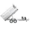 The Premium 12×7 Hydraulic 3-Way Tipper Galvanised Flat Top Trailer 4500kg ATM (Pre-order), a dual-axle silver utility trailer with wire mesh sides, is shown tilted upward for dumping. It features a spare tire mounted on the front and a metal storage box positioned near the hitch.
