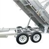 A close-up of the Premium 12×7 Hydraulic 3-Way Tipper Galvanised Flat Top Trailer 4500kg ATM (Pre-order), featuring its dual wheel sets and showcasing the hydraulic lift mechanism as it raises the trailer bed.