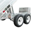 Close-up of the Premium 12×7 Hydraulic 3-Way Tipper Galvanised Flat Top Trailer (4500kg ATM, Pre-order), featuring its dual-axle design with two visible wheels, a sturdy metal toolbox, and a phone number displayed on the frame. The hydraulic tipper tray is shown partially raised.