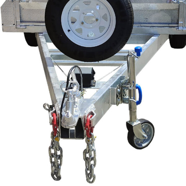 Close-up of the front section of the Premium 8x5 Dual Axle Heavy Duty Tandem Trailer – 425mm High Sides 3500KG ATM, featuring a robust metal trailer hitch with safety chains, a wheel jack, a conveniently mounted spare tire above, and a secure coupling mechanism.