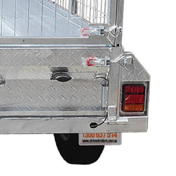 Close-up of the back corner of the Premium 8x5 Dual Axle Heavy Duty Tandem Trailer (425mm High Sides, 3500KG ATM), showing its silver metal construction, red and amber taillight, sturdy metal mesh gate, visible license plate and wheel. Part of the locking mechanism and latch are also shown.