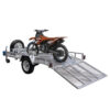 An 8×5 Heavy-Duty ATV, Zero Turn Mower, Golf Cart, Buggy Trailer – 750KG ATM with a metal mesh ramp extended to the ground secures a brown dirt bike, and features a spare tire mounted on the side.