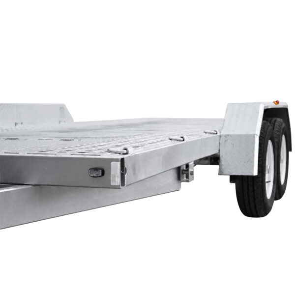 A close-up view of the Premium Hydraulic Tipper Car Trailer 4200kg ATM with metal sides, double axle wheels, and a glimpse of its 16.4×6.6FT (5x2M) loading platform and fenders.