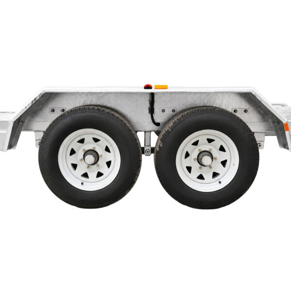 Side view of the Premium Hydraulic Tipper Car Trailer 4200kg ATM 16.4x6.6FT (5x2M) Deck Size - Punched Floor, featuring a dual axle with two black tires on white rims mounted to a sturdy metal frame, and equipped with both a red reflector and a yellow reflector above the wheels.