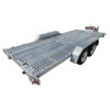 The Premium Dual Axle Car Trailer 4200kg ATM 16.4×6.6FT (5x2M) Deck Size – Punched Floor (Pre-order) is a silver metal car trailer featuring dual axles, wheel arches, a hitch for towing, and a perforated ramp, shown from the back corner.