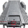 A close-up view of the Premium Dual Axle Car Trailer 4200kg ATM 16.4×6.6FT (5x2M) Deck Size with a punched floor, featuring a built-in winch system and perforated side panels, designed for efficient loading or unloading of vehicles.