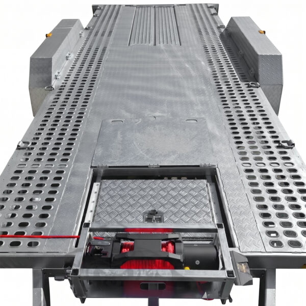 A close-up view of the Premium Dual Axle Car Trailer 4200kg ATM 16.4×6.6FT (5x2M) Deck Size with a punched floor, featuring a built-in winch system and perforated side panels, designed for efficient loading or unloading of vehicles.