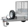 A close-up of the 8×5 Dual Axle Hydraulic Tipper Tandem Box Trailer 3200kg ATM (Pre-order) shows a spare tire, wire mesh cage, small storage box, and a tow hitch with safety chains.