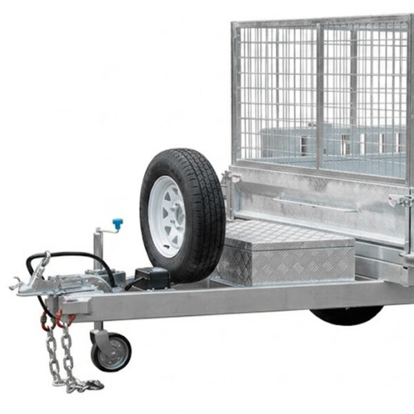 A close-up of the 8×5 Dual Axle Hydraulic Tipper Tandem Box Trailer 3200kg ATM (Pre-order) shows a spare tire, wire mesh cage, small storage box, and a tow hitch with safety chains.
