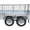 A close-up side view of the 8×5 Dual Axle Hydraulic Tipper Tandem Box Trailer 3200kg ATM (Pre-order) featuring two wheels with white rims and a wire mesh cage on top.