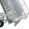 Close-up of an 8×5 Dual Axle Hydraulic Tipper Tandem Box Trailer 3200kg ATM (Pre-order) with a mesh ramp gate partially open, revealing the wheel and sturdy metal framework. The trailer is shown in a tilted position for easy loading or unloading.