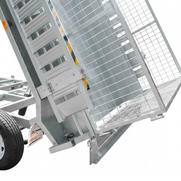 Close-up of an 8×5 Dual Axle Hydraulic Tipper Tandem Box Trailer 3200kg ATM (Pre-order) with a mesh ramp gate partially open, revealing the wheel and sturdy metal framework. The trailer is shown in a tilted position for easy loading or unloading.