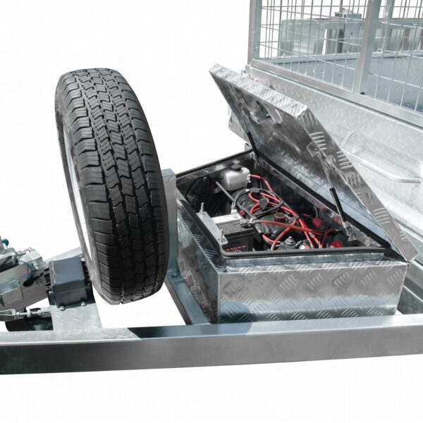 Close-up of the 8×5 Dual Axle Hydraulic Tipper Tandem Box Trailer 3200kg ATM (Pre-order) showing its metal frame with a mounted spare tire and an open toolbox revealing the battery and internal wiring. The surface is finished with a diamond plate pattern.